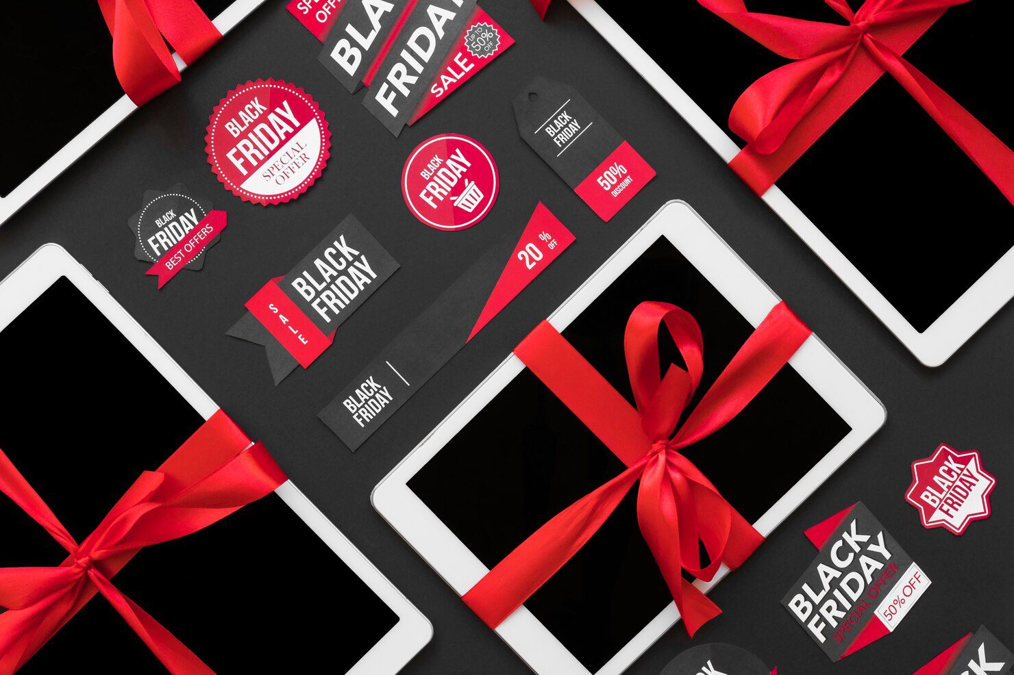 Black Friday promotional tags and labels around tablets